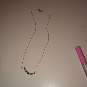 The color is green and grey it is a necklace it. Is 10$ it was 30$